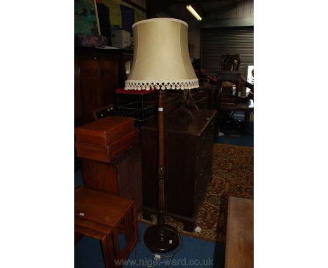 A Mahogany standard Lamp with yellow shade
