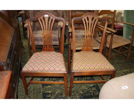 A pair of light Mahogany Georgian style Dining Chairs having a hump back with fret cut pierced splats and tapestry style shel