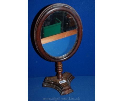 A free standing oval Mahogany Mirror.