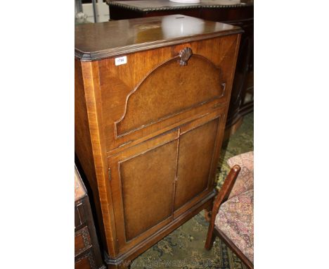 A 1950's Queen Anne style Walnut finished Cocktail Cabinet by G & F Gold Feather Products with fall front and automatic lifti