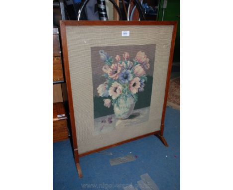 A framed Firescreen decorated with a vase of flowers