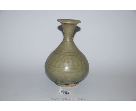 A fine Thai Sawankhalok celadon glazed bottle Vase, 14th-15th century with simple incised decoration and a delicate green col