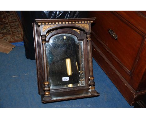 A 19th c. Wall Mirror with stained Pine frame painted with gold decoration and having a moulded top on tapering multi-faceted