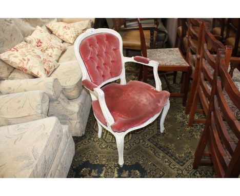 A reproduction French Empire style Elbow Chair with ornate cream painted crackle finish show frame, button upholstered back a