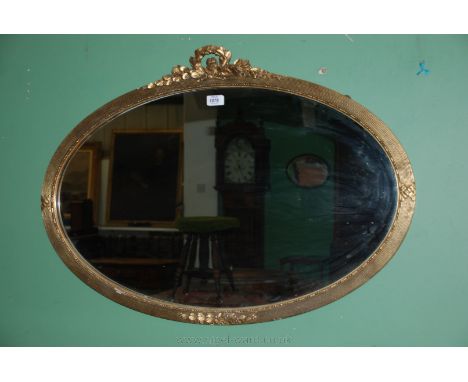 A gilt framed oval Mirror with laurel leaf pediment