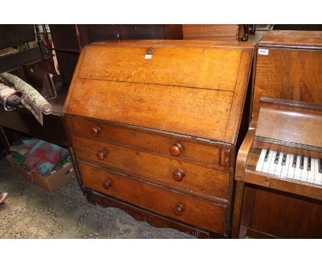 An early 19th c. Oak Bureau having plain top, the cleated edge fall opening to reveal eleven pigeon holes and four small draw