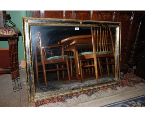 A modern Brass framed cushion Mirror, 28" x 40 1/2".