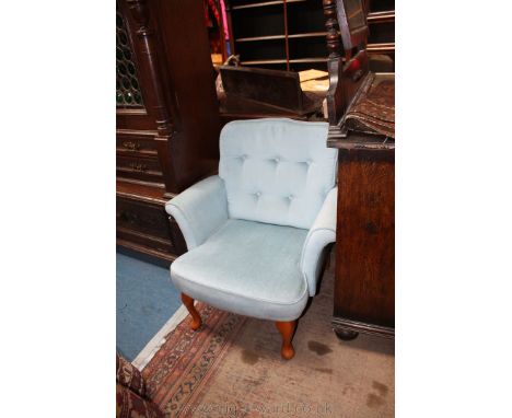 A modern blue draylon button back Nursing Chair on Beech legs.