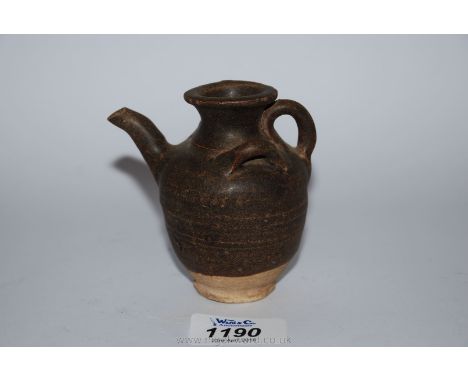 A Thai Sawankhalok oil lamp, 15th-16th century, of a rare form suggesting the appearance of a blow fish with three rudimentar