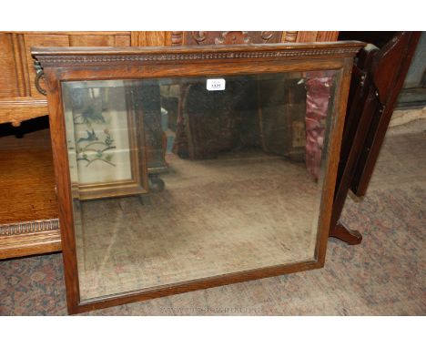 An Oak framed bevel plated Mirror with decorative pediment, 26'' x 23''.
