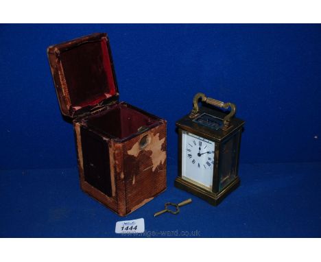 A brass Carriage Clock in original case and with key, 4 1/2'' tall.