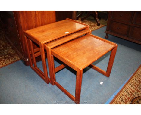 A 1970's Nest of three G-Plan style Teak Occasional Tables having plain rectangular solid tops, on rectangular form legs, lig