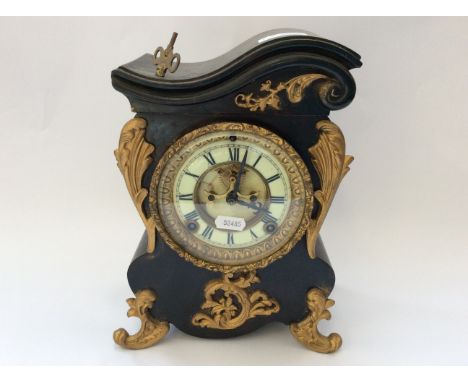 An Ansonia, New York, American style wooden mantel clock with gold painted brass Classical style decoration.