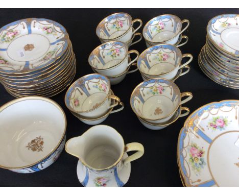 A Noritake tea set with six tea cups and saucers, two large and twelve small plates, a sugar bowl and milk jug.