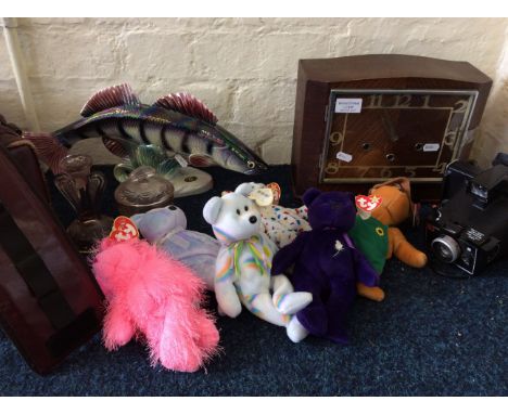 An oak mantel clock with two bags of beanie babies, cameras, ceramic fish ornament , books, pink glass, etc.