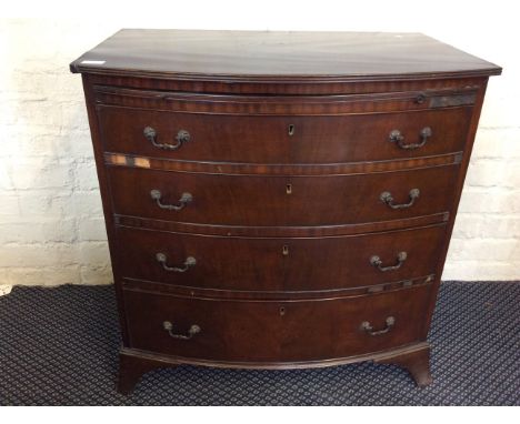 A four drawer bow fronted chest on bracket feet.