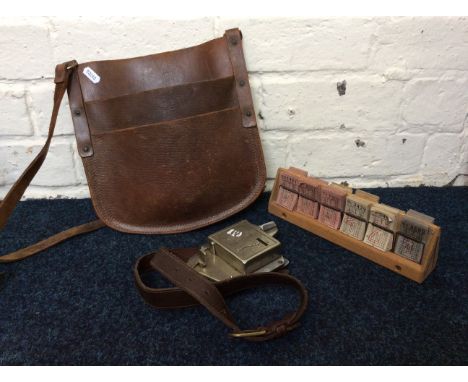 A London bus ticket punch with leather pouch and tickets.