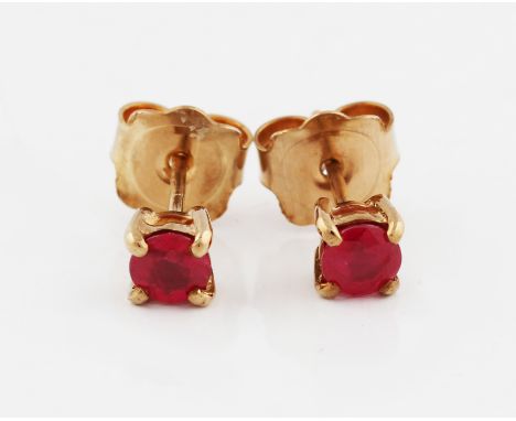 A pair of 9ct yellow gold ruby stud earrings, each set with a round cut ruby, measuring approx. 4mm, hallmarked London 2012, 