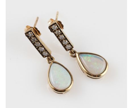 A pair of opal and diamond drop stud earrings, each set with a pear shaped opal cabochon, surmounted with a row of five round