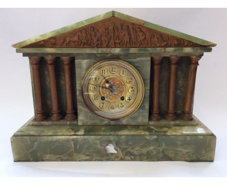 An Onyx mantel clock in the form of a Classical temple.
