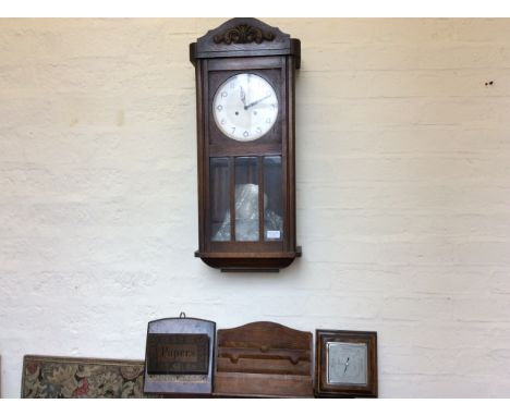 A 1930s wall clock with a letter holder, barometer and paper holder.