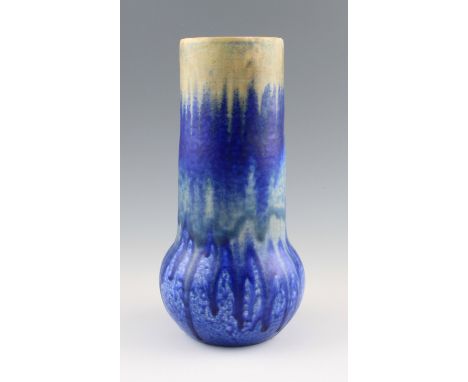 A Ruskin Pottery matt crystalline elephants foot vase with tall cylindrical neck, body having cream, blue, beige and blue col