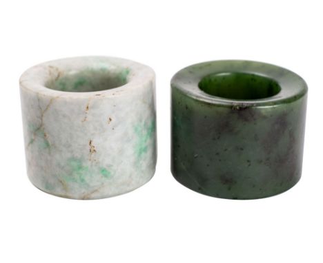 A Chinese spinach jade archer's ring and a similar jadeite archer's ring, 19th/20th century  the first with dark grey/black i