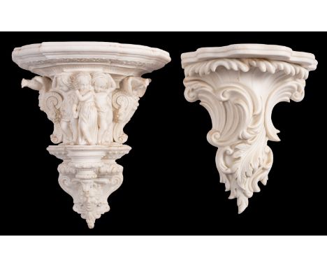 Two Parian wall brackets, one of scrolling foliate form and the companion of architectural form centred with three children f