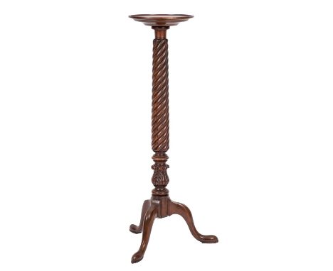 A carved mahogany circular torchere stand, in the Regency taste, 20th century; with spirally reeded and acanthus carved colum