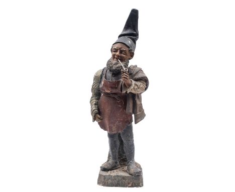 A German or Austrian cold painted terracotta garden gnome, modelled smoking a pipe and wearing a pointed hat, leather apron a
