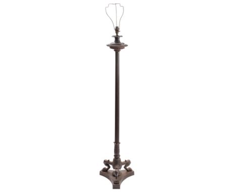 A Regency cast iron standard lamp, circa 1815 and later adapted for electricity; with a fluted boss with egg-and-dart cast ri