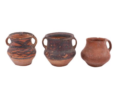 A group of three Chinese Neolithic terracotta jars two with black painted geometric decoration, 9 and 11cm [damages and repai