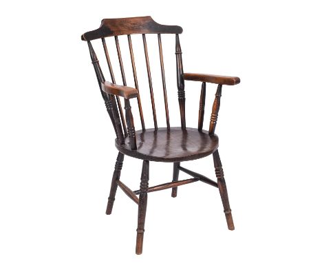 An elm and beech elbow chair in the style of a Windsor chair, late 19th century; the shaped spindle back  with curved arm res