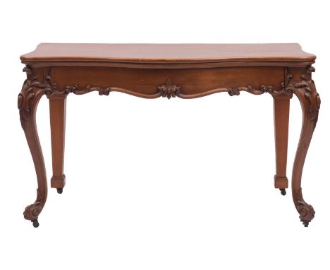 A carved oak serpentine fronted serving or console table in Louis XV style, mid 19th century; the top with moulded edges abov