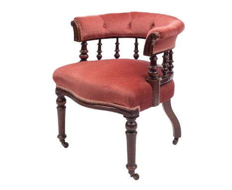 A Victorian mahogany and upholstered tub elbow chair, third quarter 19th century; with later red velvet coverings and knopped
