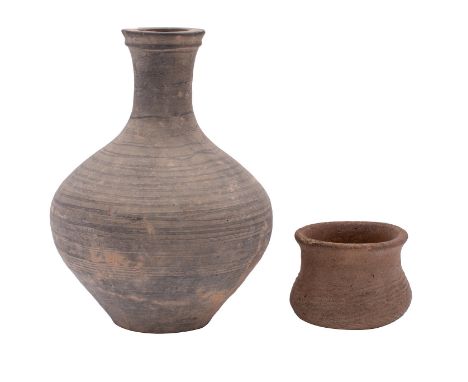 A Chinese Neolithic grey pottery vessel and one smaller the first with black painted horizontal bands, 26cm [rim chips]; the 
