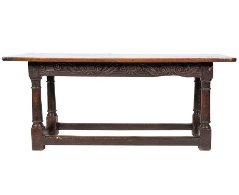 A mid 17th-century oak rectangular serving table; frieze with incised carved scrolling foliage, on ring turned and block stre