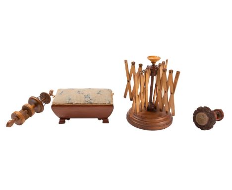 A Victorian treen bobbin stand, late 19th century; with turned table clamp base, 21cm high; another clamp with pin cushion; a