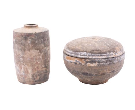 A Chinese Neolithic grey pottery bowl and cover and a similar jar both painted with scrollwork, 17 and 16.5cm [minor kiln dam
