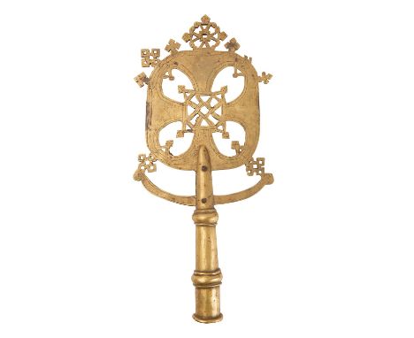 An Abyssinian Coptic Christian brass processional cross, late 19th/early 20th century; the pierced, openwork finial cut from 