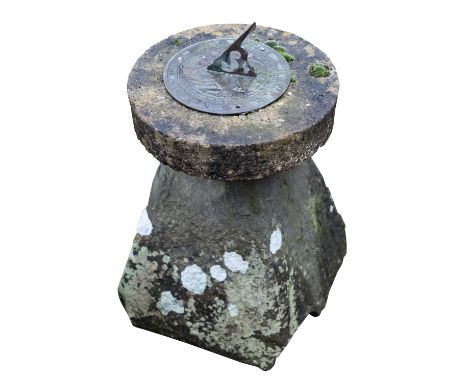 A metal garden sundial, early 20th century, mounted on a 19th century staddle base; the circular dial with gnomon, on a circu
