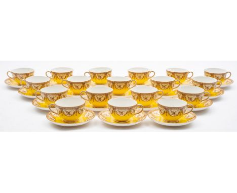 A Royal Worcester porcelain tea service, with sepia decoration on a yellow ground, comprising eighteen cups and eighteen sauc