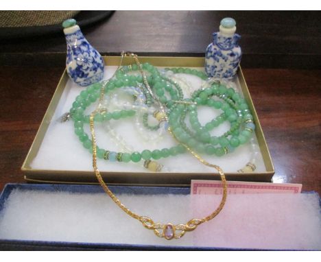 A mixed lot of costume jewellery to include an amethyst set necklace, together with two small blue and white Chinese snuff bo