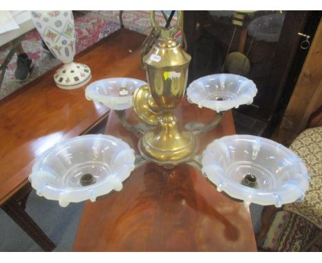 An early 20th century French brass four branch chandelier with opaque glass shades 