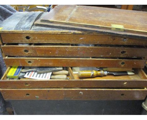 A vintage five drawer tool chest containing wooden handled and other tools 