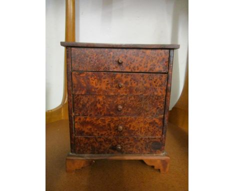A miniature burr wood chest of five drawers on bracket feet, 9 2/8" x 7 1/2" x 4 2/8" 