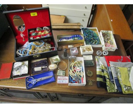 A mixed lot of costume jewellery, scarves, cap badges, silver and silver plate to include a silver napkin ring, a yellow colo