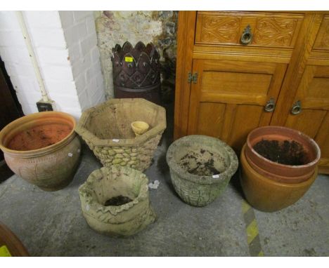 A pottery chimney pot and a selection of ceramic and garden concrete planters 