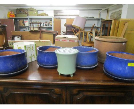 A group of ceramic planters to include four blue glazed bowls and stands 