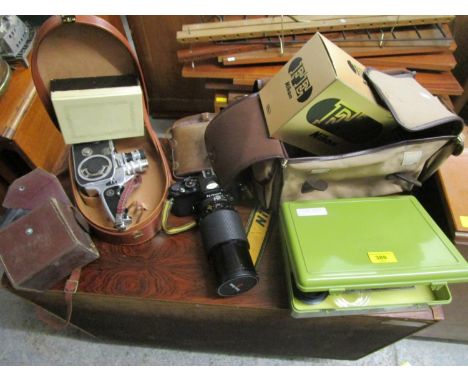 A selection of camera equipment to include a Nikon camera with lens with camera case, a cased Rolex Paillard movie camera and